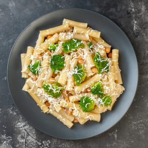 top view cooked pasta with cheese and broccoli on light gray bac